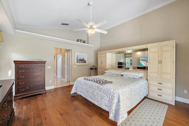 bedroom featuring ceiling fan, hardwood / wood-style floors, and lofted ceiling