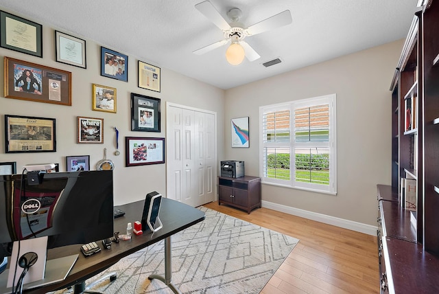 office with ceiling fan, a textured ceiling, and light hardwood / wood-style flooring