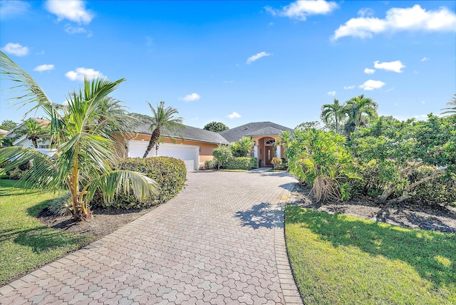 view of front of property with a front lawn and a garage