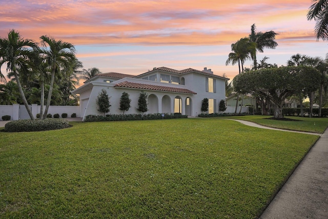 mediterranean / spanish-style house with a lawn