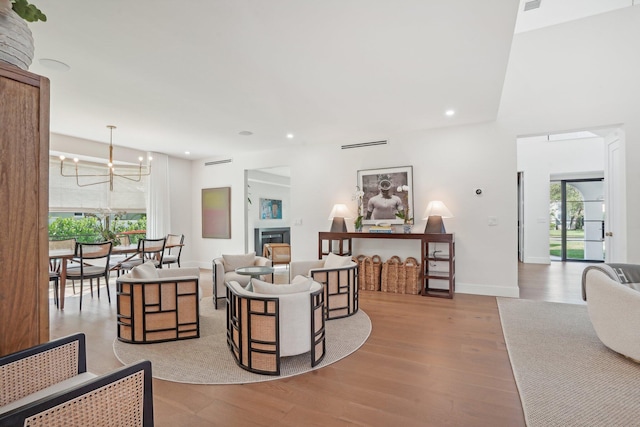 living room featuring light hardwood / wood-style flooring and a chandelier