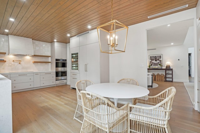 dining room with a chandelier, wooden ceiling, and light wood-type flooring