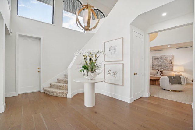 entryway featuring hardwood / wood-style flooring and a high ceiling