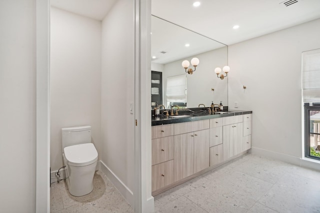 bathroom with vanity and toilet