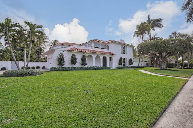 mediterranean / spanish house featuring a front lawn