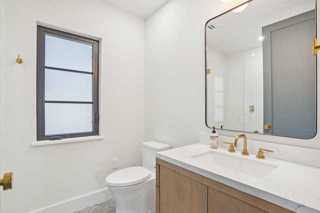 bathroom featuring toilet and vanity