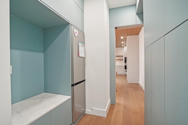 hallway with light hardwood / wood-style flooring