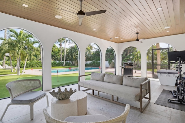 view of patio / terrace featuring outdoor lounge area, ceiling fan, grilling area, and a swimming pool