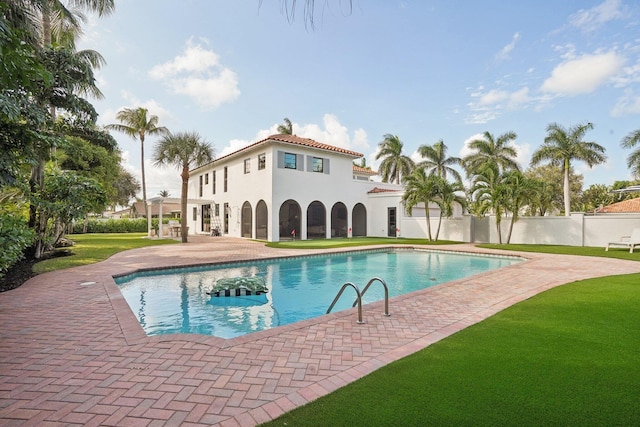 view of pool featuring a patio and a lawn