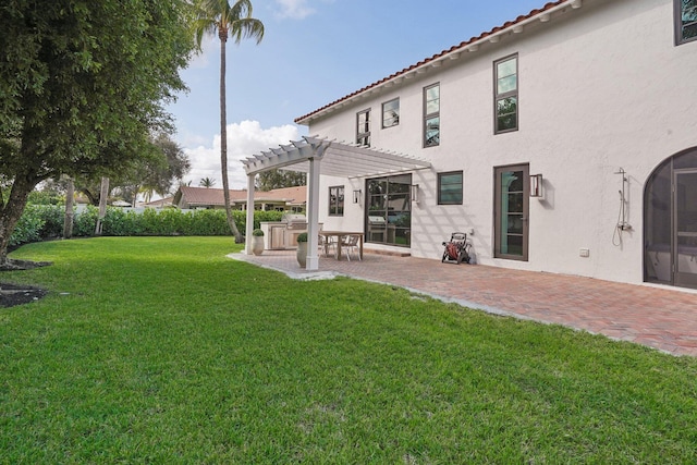 back of house with a patio area, a yard, and a pergola