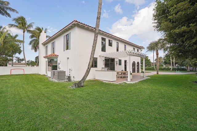 rear view of house featuring a patio, a yard, central air condition unit, and a pergola