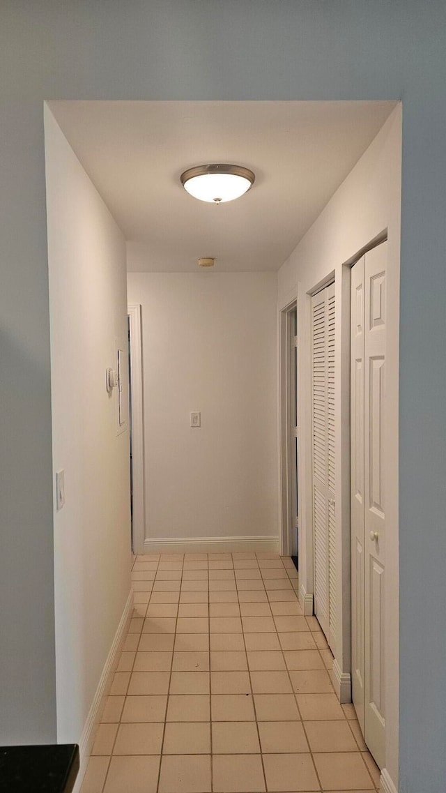 corridor featuring light tile patterned floors