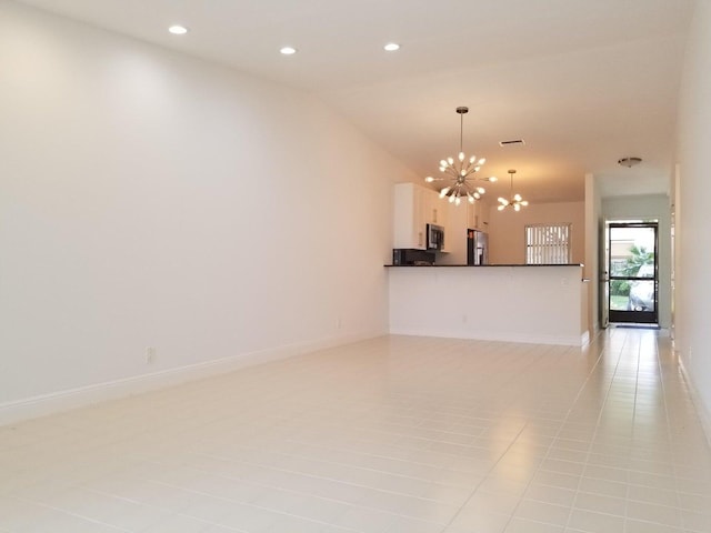 unfurnished living room with lofted ceiling, a notable chandelier, and light tile patterned floors