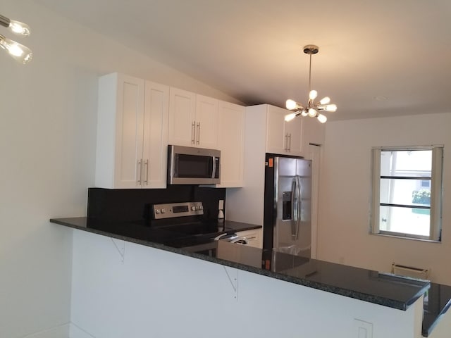 kitchen featuring kitchen peninsula, appliances with stainless steel finishes, and white cabinetry