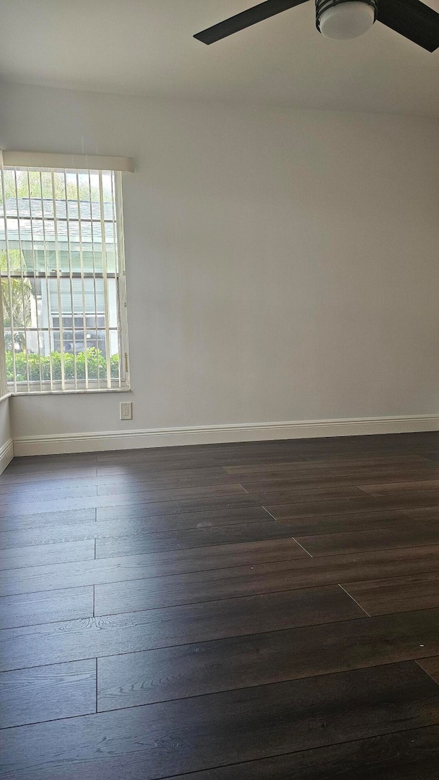 unfurnished room featuring ceiling fan and dark hardwood / wood-style floors