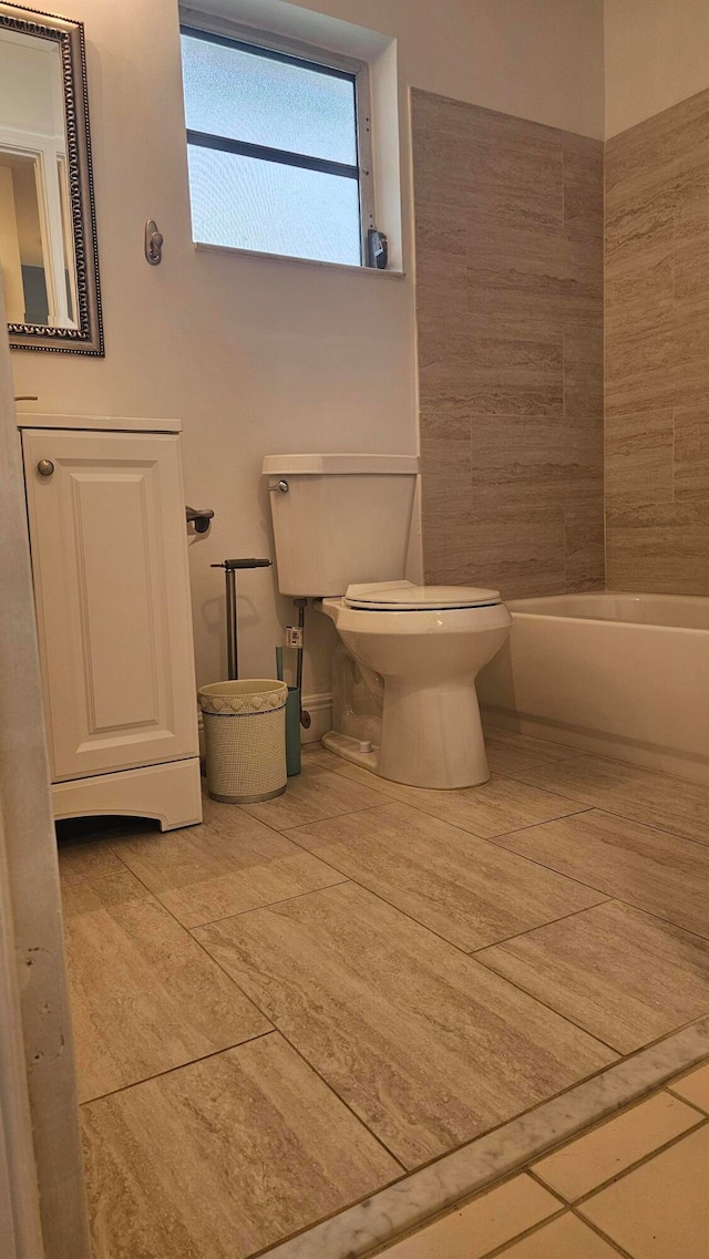 bathroom featuring a tub and toilet