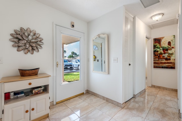 entrance foyer featuring a textured ceiling