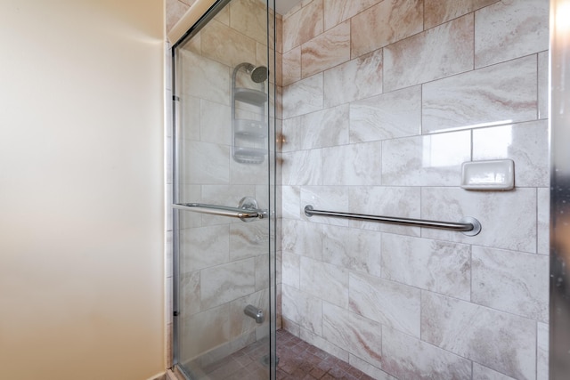 bathroom featuring a shower with door