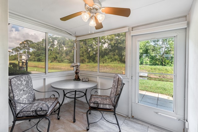 sunroom with a healthy amount of sunlight and ceiling fan