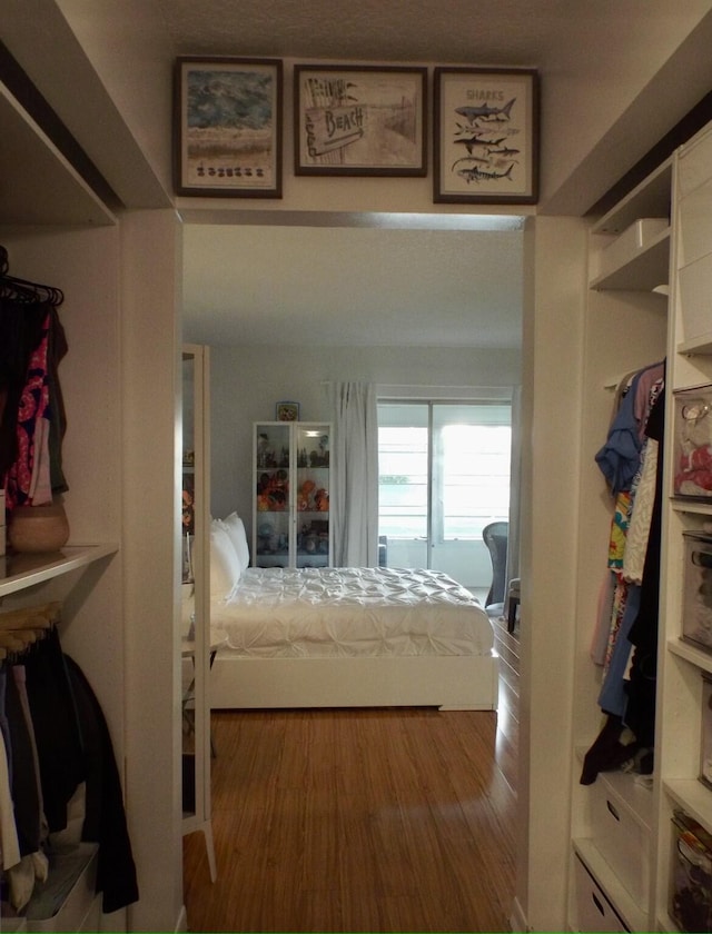 bedroom with a closet and hardwood / wood-style floors