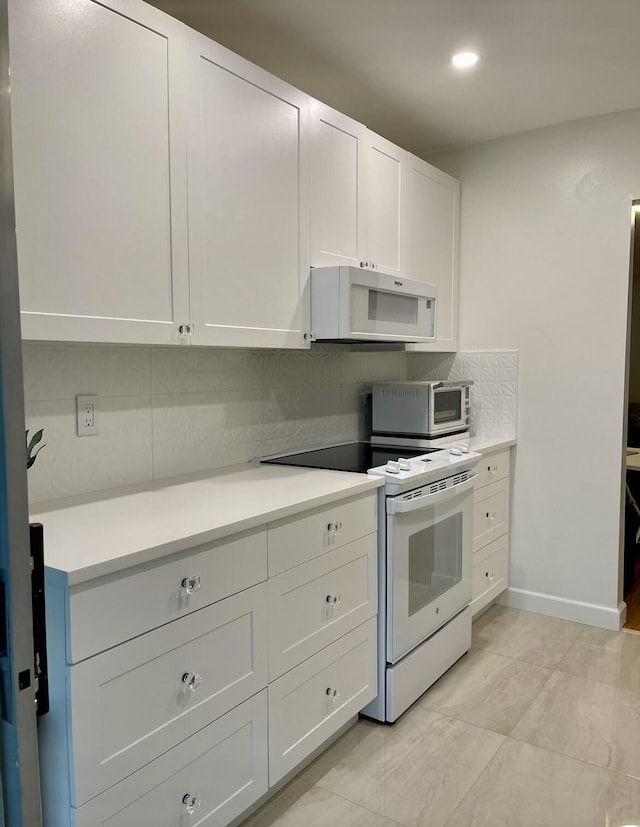 kitchen featuring white cabinets, white appliances, and tasteful backsplash