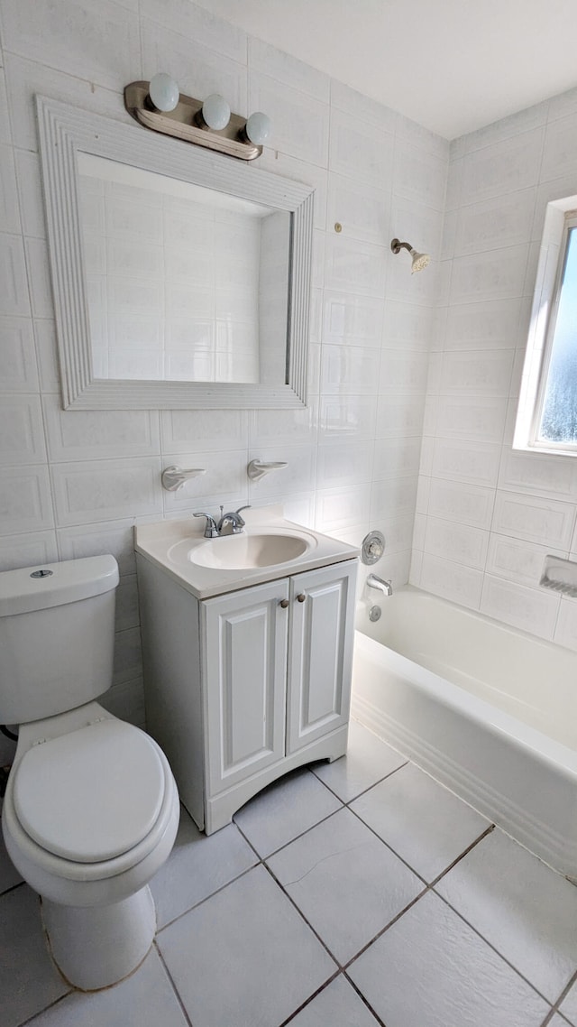 full bathroom with washtub / shower combination, toilet, tile walls, vanity, and tile patterned flooring