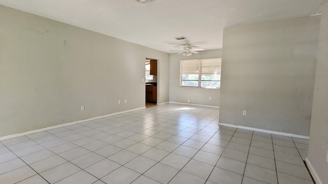 empty room featuring ceiling fan and light tile patterned floors