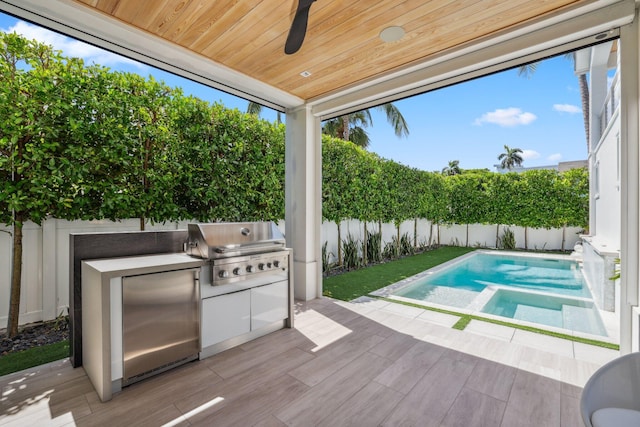 view of swimming pool featuring a patio, ceiling fan, grilling area, and exterior kitchen