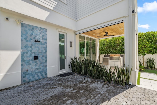 view of patio featuring area for grilling and ceiling fan