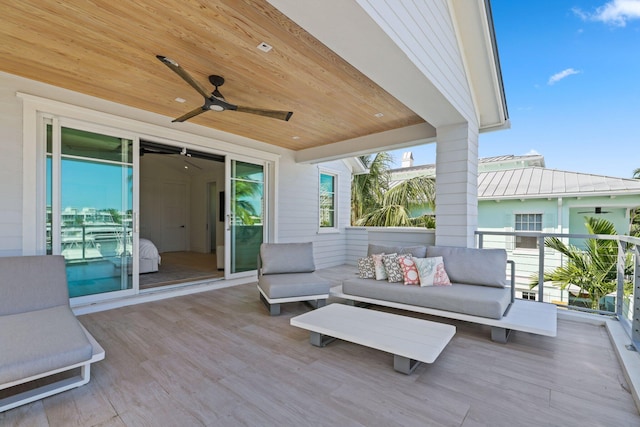 deck with ceiling fan and an outdoor living space