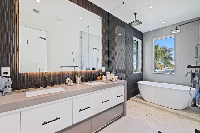 bathroom featuring vanity, independent shower and bath, and tile patterned floors