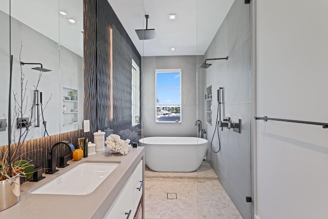 bathroom with vanity and independent shower and bath