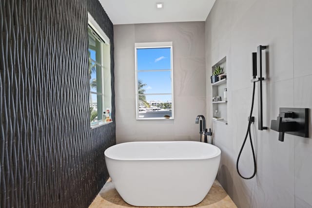 bathroom with tile walls and a washtub