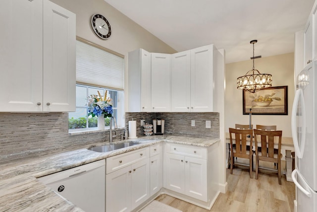 kitchen with white cabinetry, sink, and white appliances