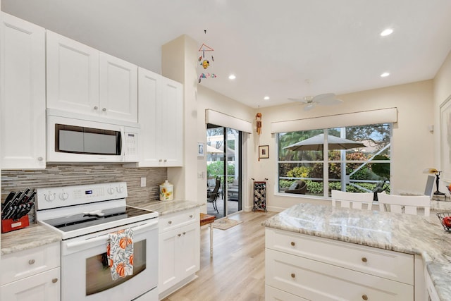 kitchen with light stone countertops, tasteful backsplash, white appliances, ceiling fan, and white cabinets