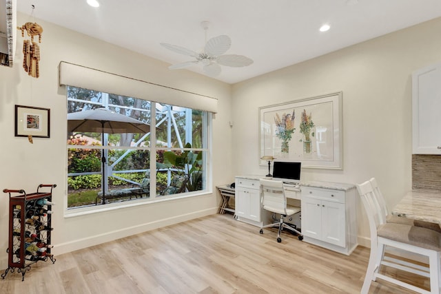 home office with light hardwood / wood-style floors, plenty of natural light, and ceiling fan