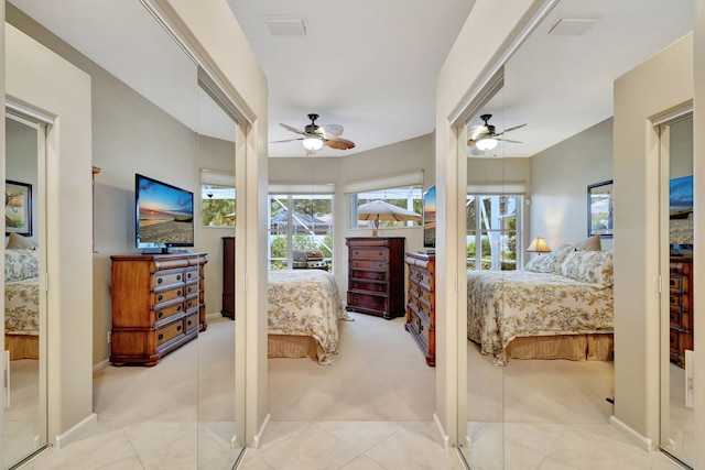 bedroom featuring multiple windows, ceiling fan, and light carpet