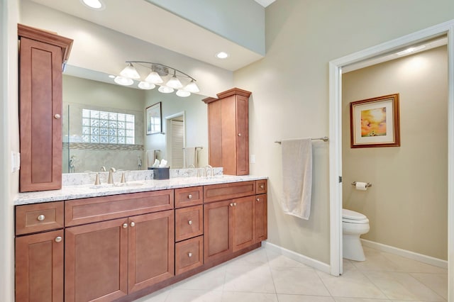 bathroom with tile patterned floors, vanity, and toilet