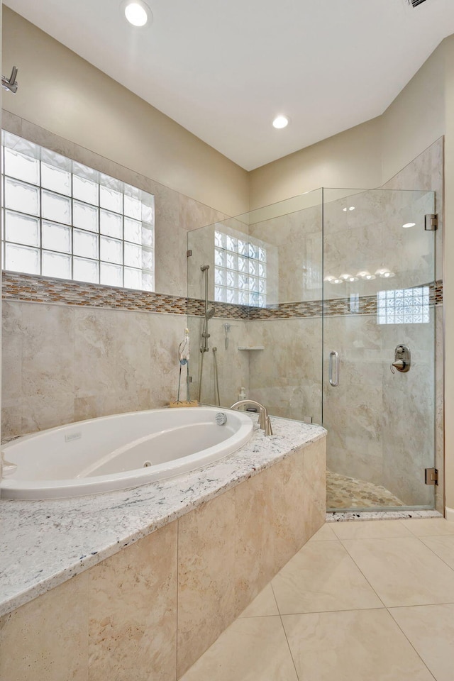 bathroom with tile patterned flooring and plus walk in shower