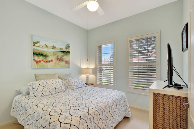 bedroom with light carpet and ceiling fan