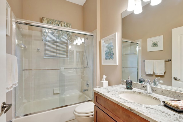 full bathroom with vanity, toilet, and enclosed tub / shower combo