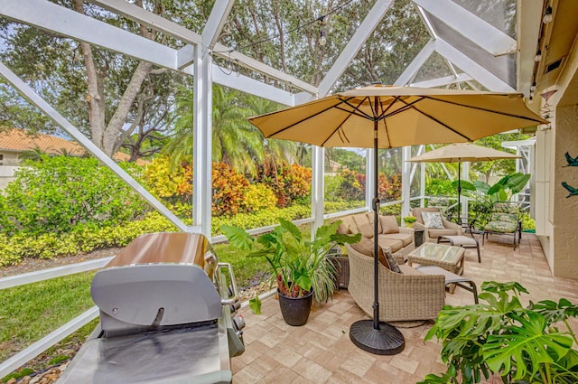 view of patio featuring grilling area, an outdoor living space, and glass enclosure