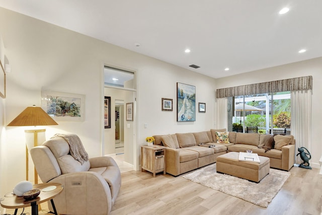 living room with light hardwood / wood-style flooring