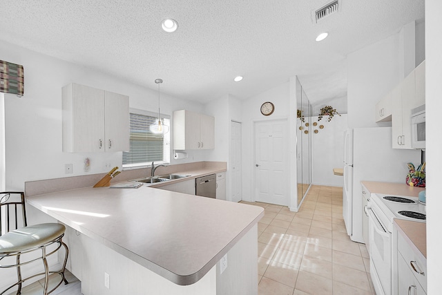 kitchen featuring a kitchen breakfast bar, hanging light fixtures, kitchen peninsula, white cabinets, and white appliances