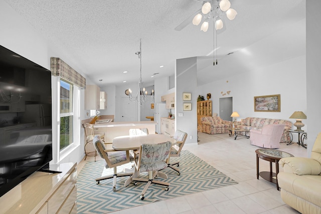 tiled dining area featuring a notable chandelier and a textured ceiling