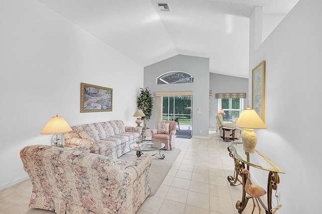 living room with high vaulted ceiling, a textured ceiling, and light tile patterned floors