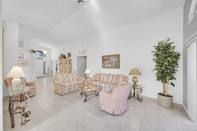 living room with high vaulted ceiling and light tile patterned floors