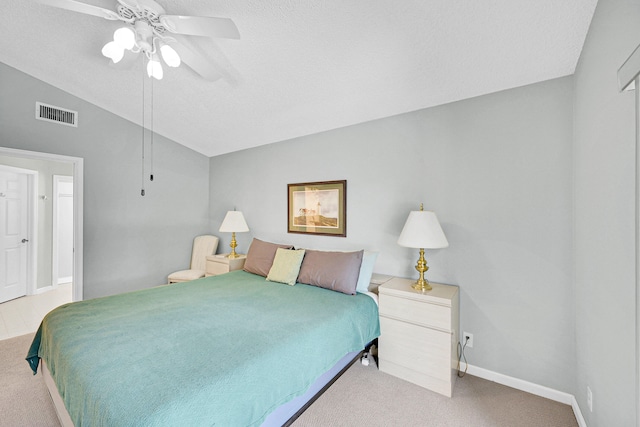 carpeted bedroom with lofted ceiling, a textured ceiling, and ceiling fan