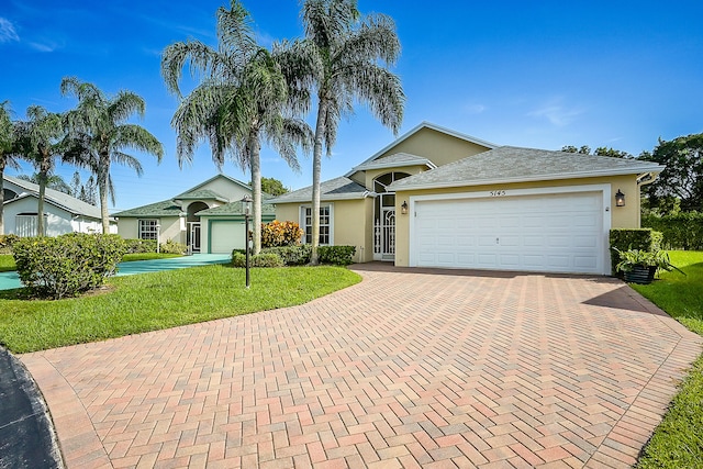 view of front of house with a garage and a front lawn