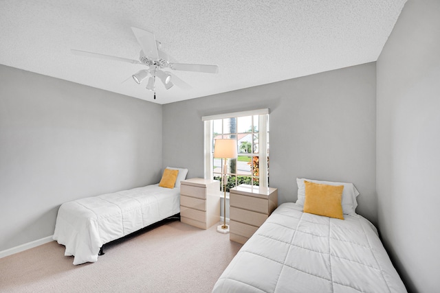 carpeted bedroom with a textured ceiling and ceiling fan